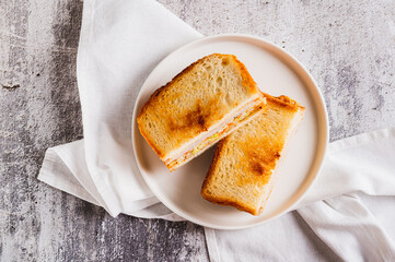 Close up of gilgeori toast with cabbage, carrot, ham and cheese on a plate on the table top view