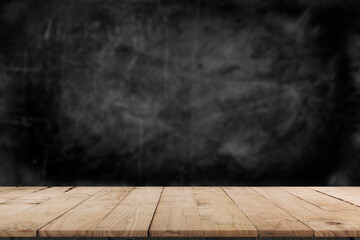 Wooden table in dark room background concept for advertising.
