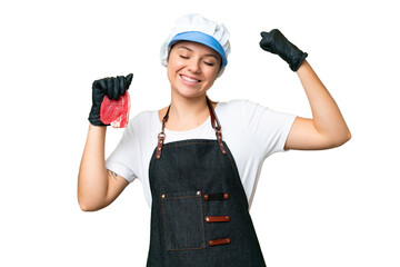 Butcher woman wearing an apron and serving fresh cut meat over isolated chroma key background doing strong gesture