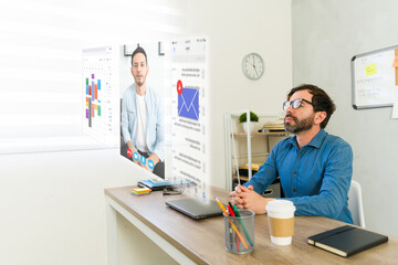 Professional employee utilizing augmented reality smart glasses during video conference, checking...