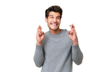 Young handsome caucasian man over isolated background with fingers crossing