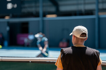 Tennis player, playing on a hard court playing a tennis match in summer