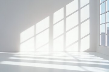 Obraz premium A bright, minimalistic interior space featuring sunlight casting geometric shadows on a white wall and floor.
