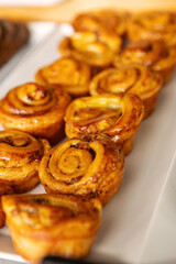Freshly baked pastries sweet rolls displayed on buffet table in cozy bakery or cafe setting for Breakfast, Brunch and Dessert Lovers Savoring Sweet and Savory Treats