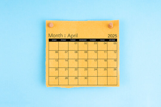 April 2025 brown calendar with wooden thumbtack on blue background.