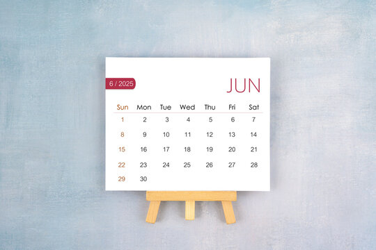 June 2025 calendar page with wooden easel.