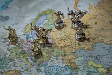 The Roman warrior pawns fight a battle on the world map. War between Russia and Ukraine