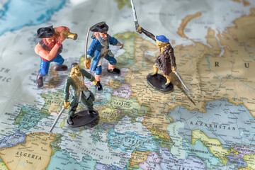 The children's pirate figures play a battle on the flat world map.