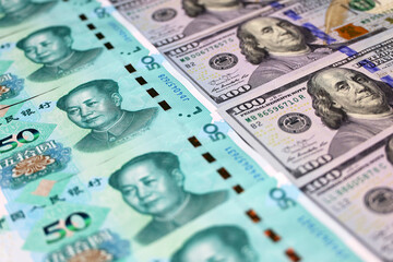Chinese yuan banknotes and US dollars. Concept of trade war between the China and USA, economic,...