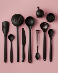 An array of stylish black kitchen utensils arranged neatly on a pink background. Ideal for modern culinary creations and food preparation aesthetics.