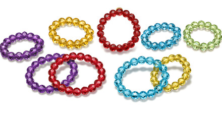 A collection of colorful crystal bead bracelets arranged on a white surface in an artistic manner