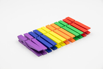 colorful household wooden сlothes pins isolated on white background.