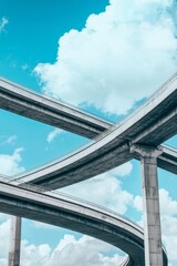 A modern highway interchange with concrete overpasses against a blue sky