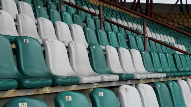 Green and white stadion chair in europe. A field of empty stadium seats