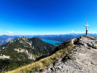 Scenic view of the summit cross with the German alps and a lake in the background