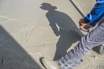 Hand worker brush rough mix concrete floor for smooth manual well free space for text with...