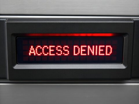 A red "ACCESS DENIED" message displayed on a digital screen, indicating restricted entry or permission issues.
