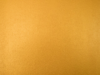 Gold color background. Rough gold texture design on the wall.