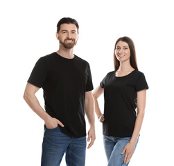 Fototapeta premium Woman and man wearing blank black t-shirts on white background. Mockup for design