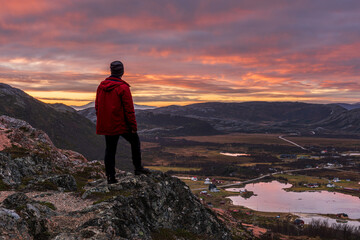 Traveller enjoying sunrise in Norway