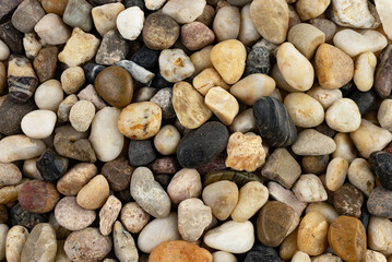 Textures of beach pebbles in various shapes and colors
