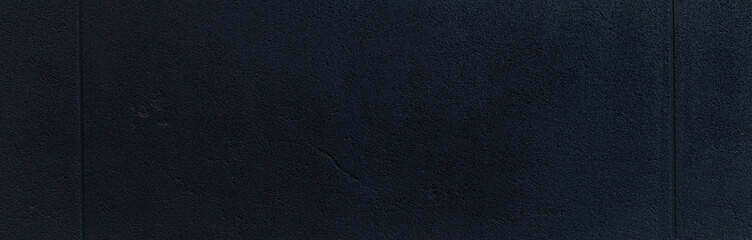 Detailed texture of dark concrete wall with rough surface, seen up close
