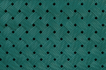 Detailed texture of green plastic surface in the shape of diamonds, close-up view