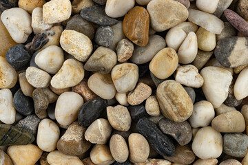Textures of beach pebbles in various shapes and colors
