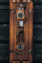Fototapeta premium Rusted Electrical Panel with Exposed Wiring and Vintage Components