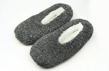Pair of fluffy and fuzzy indoor winter slippers isolated on white background
