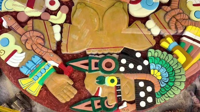 A sculpture of a man with a snake around his neck. The man is laying on the ground