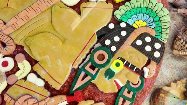 A man with a green headdress and a red and green face. The man is wearing a necklace