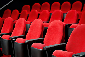 Fototapeta premium Red theater seats arranged for immersive viewing experience in cinema
