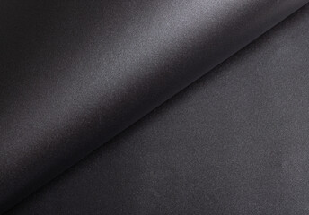 Elegant black paper texture with a shimmering, glittering finish and subtly rolled, curved edges....