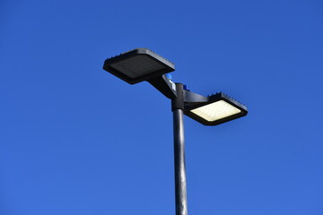 Light pole in parking lot. One light burnt out. LED