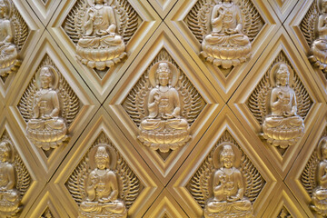 A stunning golden relief of Buddha statues arranged in a symmetrical diamond pattern. This...