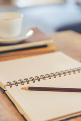 Agenda, planner book, calendar, and pencil place on business office desk. Diary for organizer to plan timetable, daily appointment, and management job at room-vertical image.