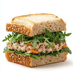 A delicious tuna salad sandwich on whole wheat bread with fresh arugula is perfectly prepared for a healthy lunch.