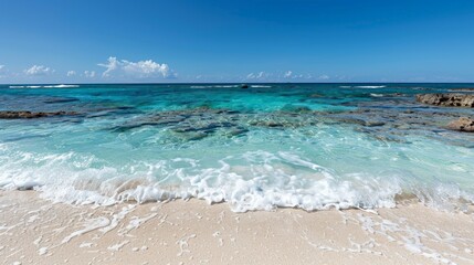 Fototapeta premium Tranquil tropical beach with clear blue waters and gentle waves