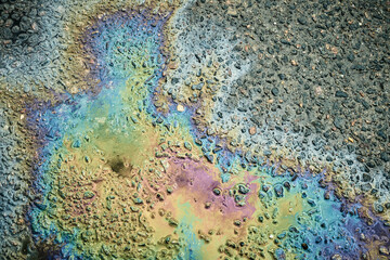 Oil Slick on Asphalt Creating Vibrant Rainbow Colors After a Rain Shower