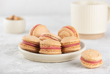 Vegan homemade macaroons with cup of coffee on white table. Healthy dessert.
