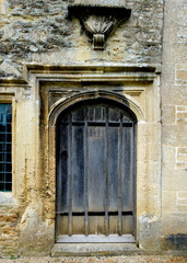 old wooden door in stone wall
