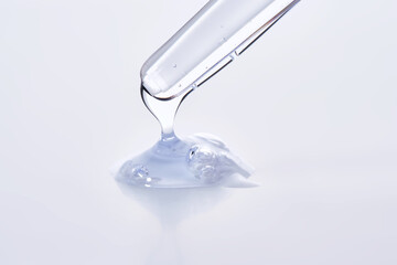Pipette with delicate blue serum close-up.