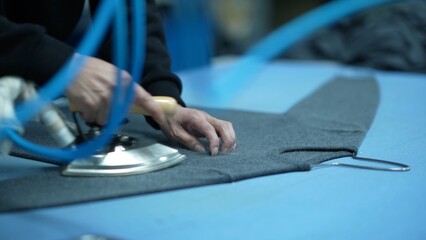 Workers in the garment factory are ironing clothes