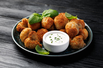 Crispy Breaded Garlic Mushrooms with garlic sauce. Vegetarian, vegan food concept
