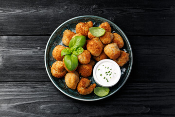 Crispy Breaded Garlic Mushrooms with garlic sauce. Vegetarian, vegan food concept