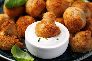 Crispy Breaded Garlic Mushrooms with garlic sauce. Vegetarian, vegan food concept