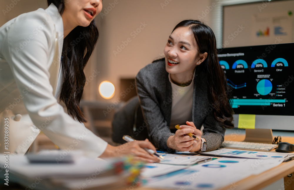 Aufkleber asian businesswomen working together using data and computer in office at night