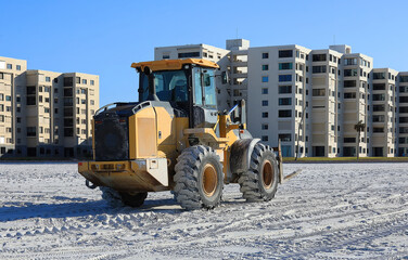 Forklift working on Fort Myers Beach to restore sand after hurricane damage.