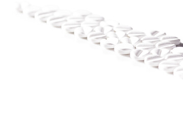 Fototapeta premium White Pills Arranged Diagonally in a Minimalist Composition on White Background